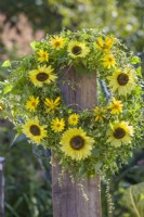 Wreath made of sunflowers, rudbeckia and wild buckwheat.