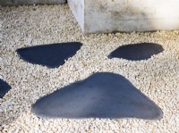 Detail of a path with irregular stepping stones.  The Shifting Garden, Designer: The Chelsea Gardener, RHS Chelsea Flower Show 2023