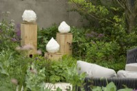 RHS Chelsea Flower Show 2023 - Sculptures on plinths in The RBC Brewin Dolphin Garden designed by Paul Hervey-Brookes Silver-Gilt