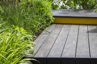 A boardwalk made from reclaimed wood with grasses planted alongside - Hurtigruten: The Relation-Ship Garden, Max Parker-Smith, RHS Hampton Court Palace Garden Festival
