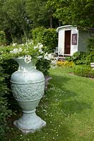 Construction trailer as a garden house, vase with jasmine, Jasminum officinale 