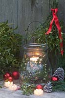 Glass lantern filled with mistletoe, Viscum album 
