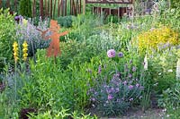 Bed with herbs and perennials, Erysimum Bowles Mauve, Spiraea japonica Goldflame, Nepeta faassenii Walkers Low 