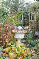 Autumn garden with stone vase and gazebo 