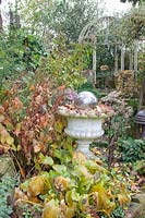 Autumn garden with stone vase and pavilion 