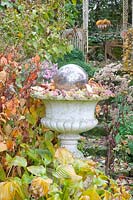 Stone vase in the autumn garden 