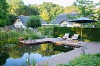 Country house garden with swimming pond 