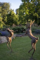 'Boxing Hares' statue by Miranda Michels at the garden of Daglinworth House, Gloucestershire