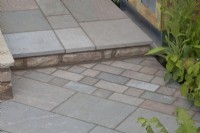 Paving set on a diagonal below step with paving set straight