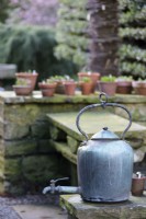 Metal kettle in a garden in February