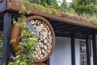 Round insect hotel made of wood and rusty ring in an urban front garden. Designer: Nicola Haines, Citroen Power of One at Bord Bia Bloom Dublin 2023