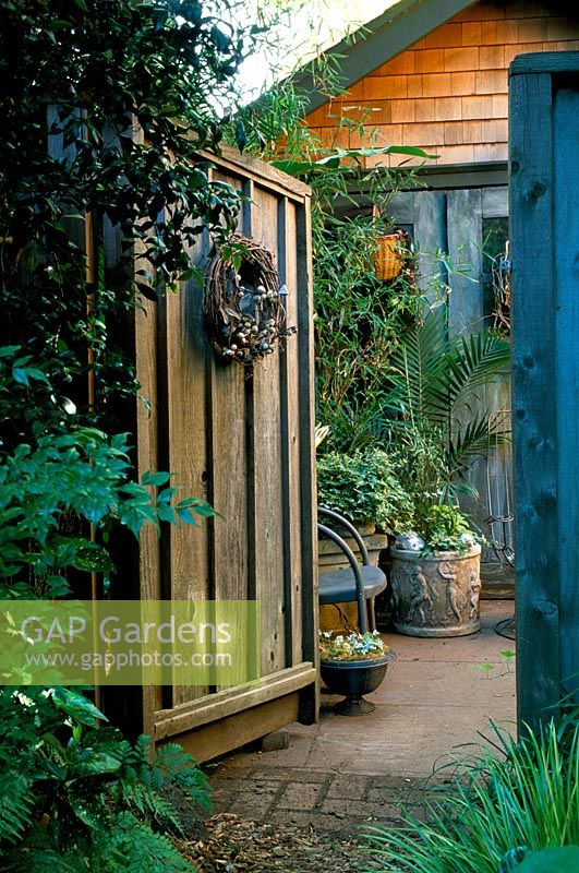 Heavy wooden garden gate at entrance to Sharon Osmond's garden in Berkeley California US