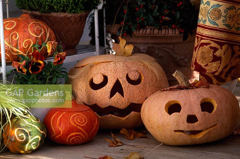 Halloween lanterns and Pumpkins decorated with cut swirly patterns