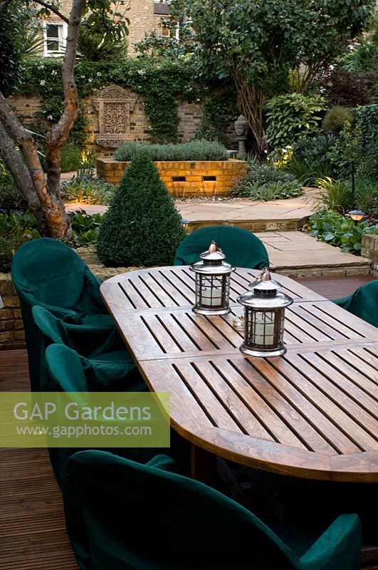 View to town garden over large wooden table and chairs