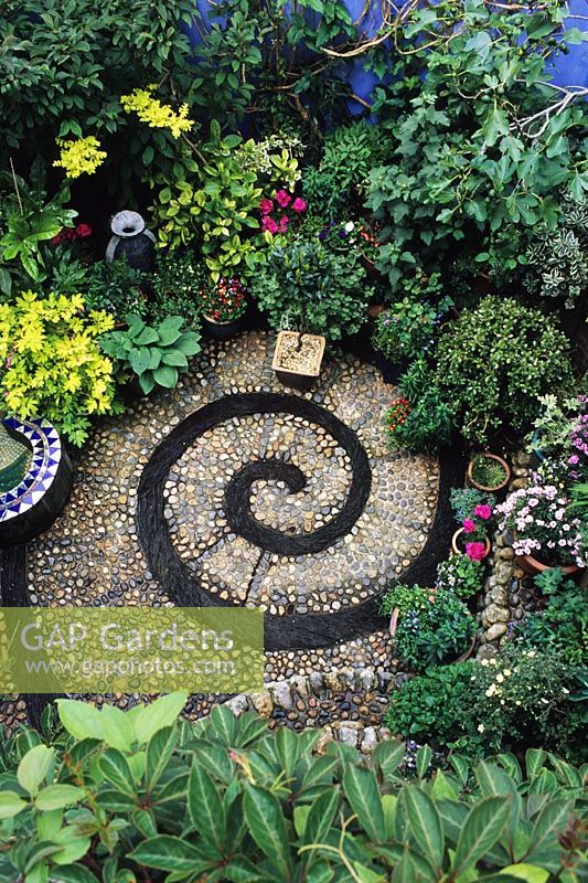 Small patio with spiral design made form cobbles and slate