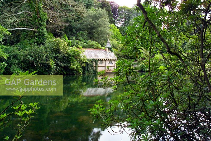 View across lake to Victorian Boathouse at trevarno Estate in Cornwall