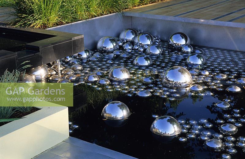 Modern pool wth metallic glass spheres at Hampton Court FS 2001.  