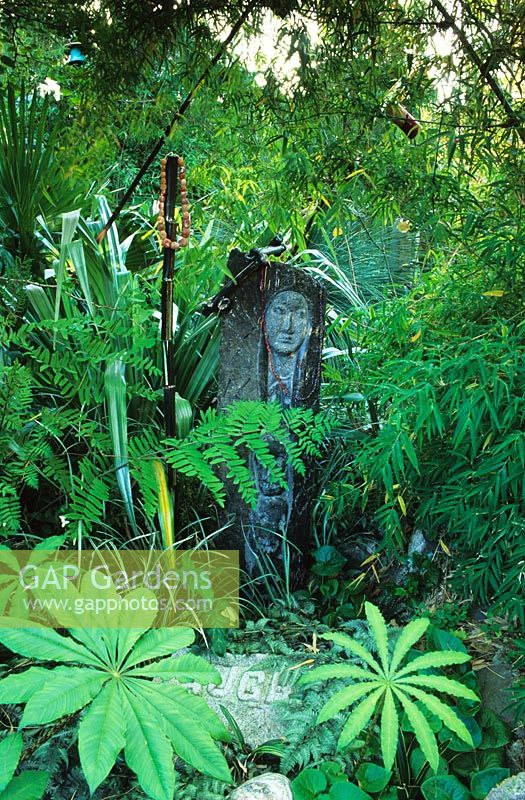 Marsha Donahue's garden in Berkeley,  California USA. Sculptural fantasy garden with Earth mother figure. 