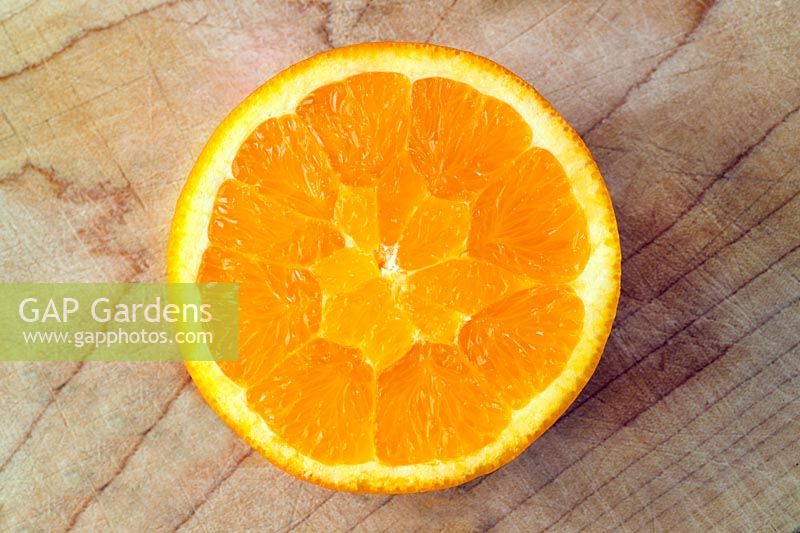 Half an orange on chopping board