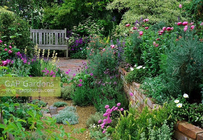 Dry garden with brick raised bed and wooden bench at Chelsea 1997