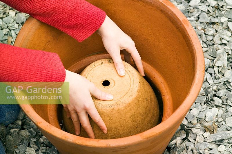 Planting pot sequence - filling bottom of large terracotta container with smaller pot upsidedown to save compost and make planted pot lighter to move