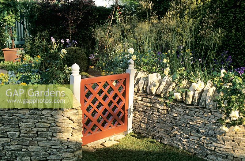 Painted wooden Garden Gate set in dry stone wall
