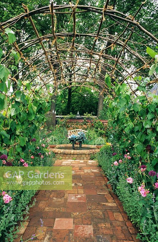 Kitchen garden with pergola, vegetables and flowers. Chelsea FS 1995