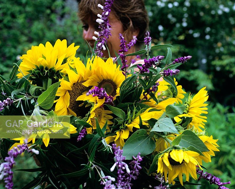 Woman carrying bunch of flowers