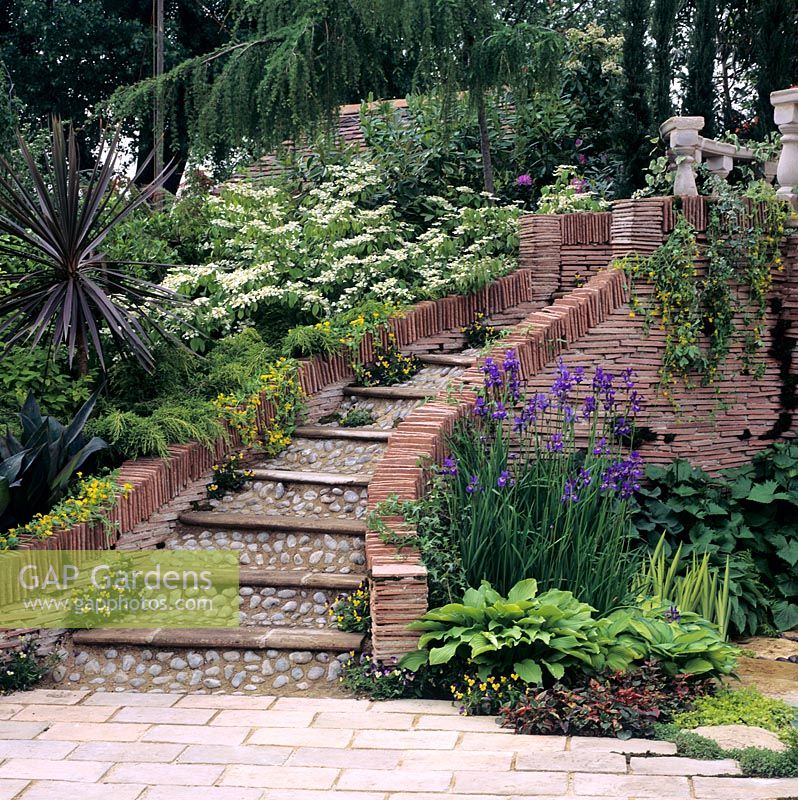 Flight of garden steps constructed using tiles, slabs and pebbles.