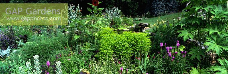 Border with Euphorbia stricta 'Gold Foam', Helianthus annuus and self sower's - Pond Garden, Chanticleer Garden, Wayne, Pennsylvania, USA.
