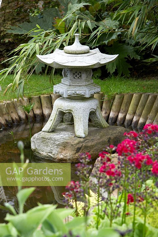 Japanese ornamental lantern in garden pond Cypress House in Dalton
