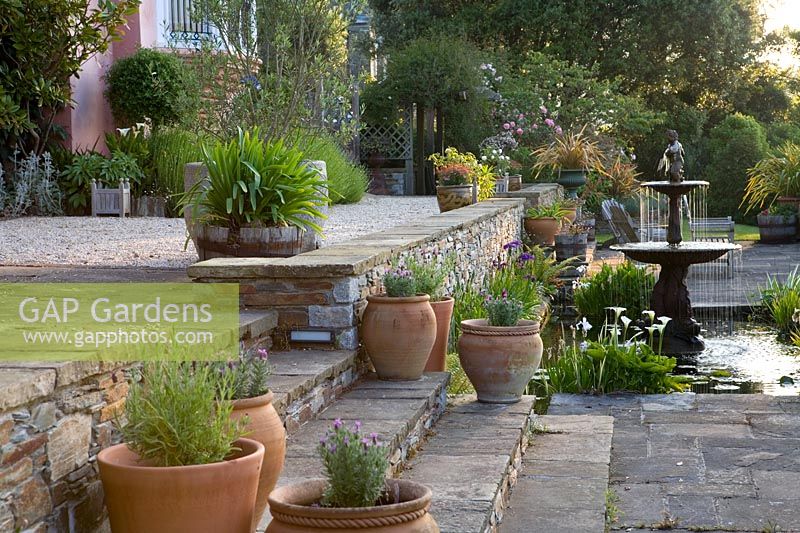 Large terrace with steps, pots and formal pond at The Moult, Salcombe, Devon