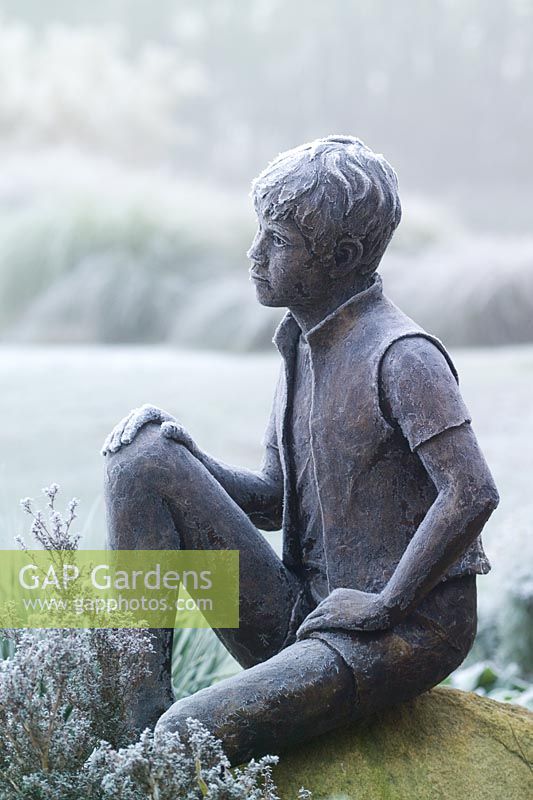 Frozen statue - 'Boy on a Rock' by Jane Hogben in John Massey's garden on a frosty winter's morning