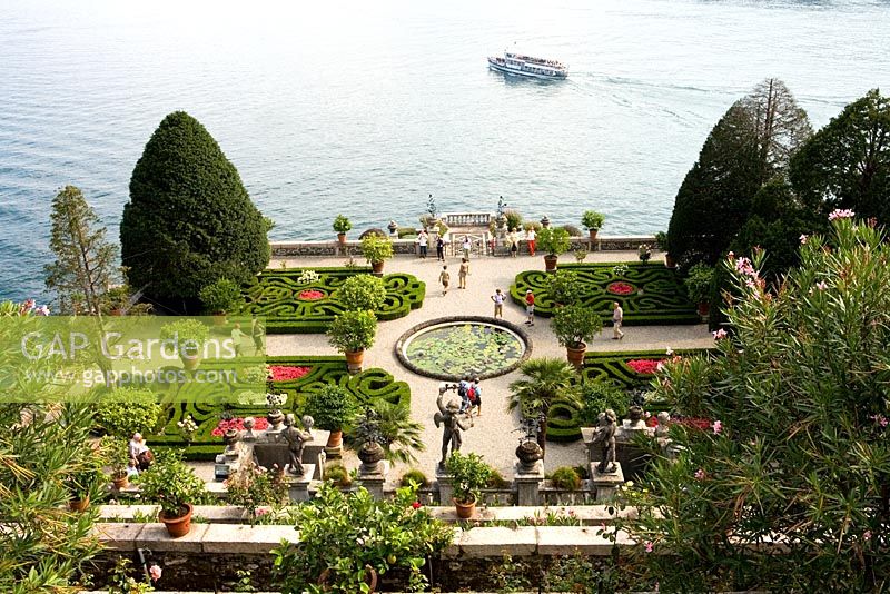Tourists in formal gardens at Isola Bella, Lake Maggiore, Piedmont, Italy - One of the Borromean Islands famous for beautiful scenic views