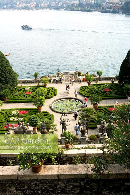 Tourists in formal gardens at Isola Bella, Lake Maggiore, Piedmont, Italy - One of the Borromean Islands famous for beautiful scenic views