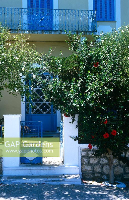Blue gate leading to courtyard and house at Cephalonia, Greece