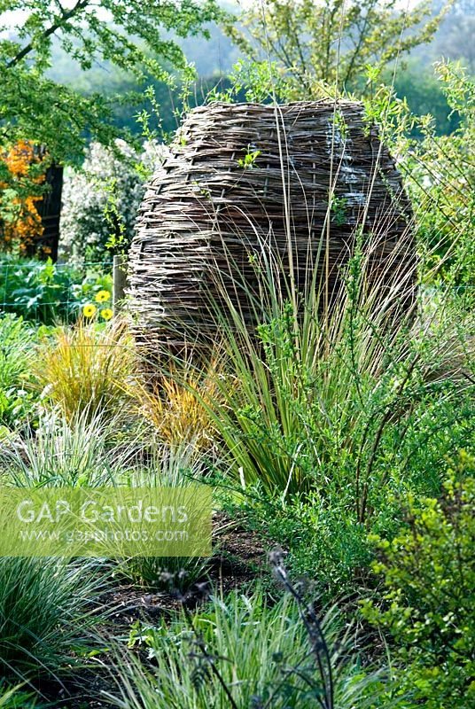 Urn made from woven willow with grasses - Lucy Redman's School of Garden Design, Nr. Bury St. Edmunds, Suffolk 