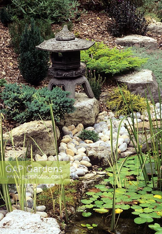 Japanese Lantern placed on rocks in Japanese garden - White Knights, Buckinghamshire