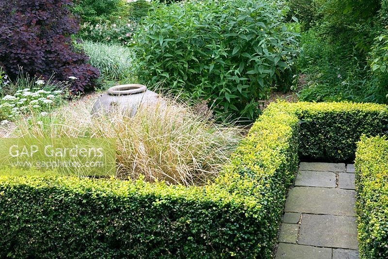 Contemporary parterre style garden with clipped hedges and grasses - Hillesley House, Gloucestershire 