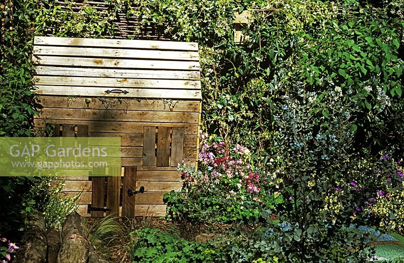 Cottage compost bin in made out of old pallets in the Round and Round The Garden - small garden at Chelsea Flower Show 2005