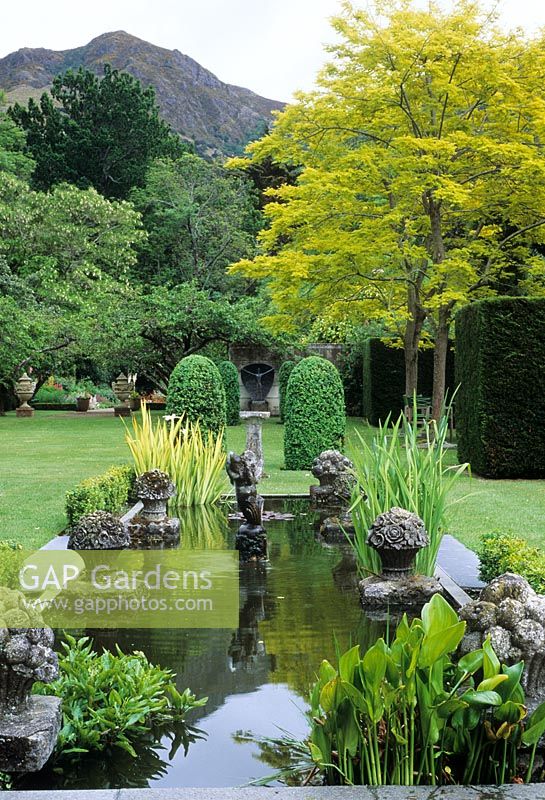 Garden pond with ornaments and aquatic planting - Ohinetahi, New Zealand
