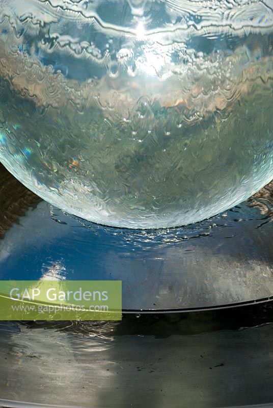 Allison Armour-Wilson's acrylic Aqualens - Acrylic ball water feature with falling water and reflection in Richard Ayres' Garden, Lode, Cambridgeshire