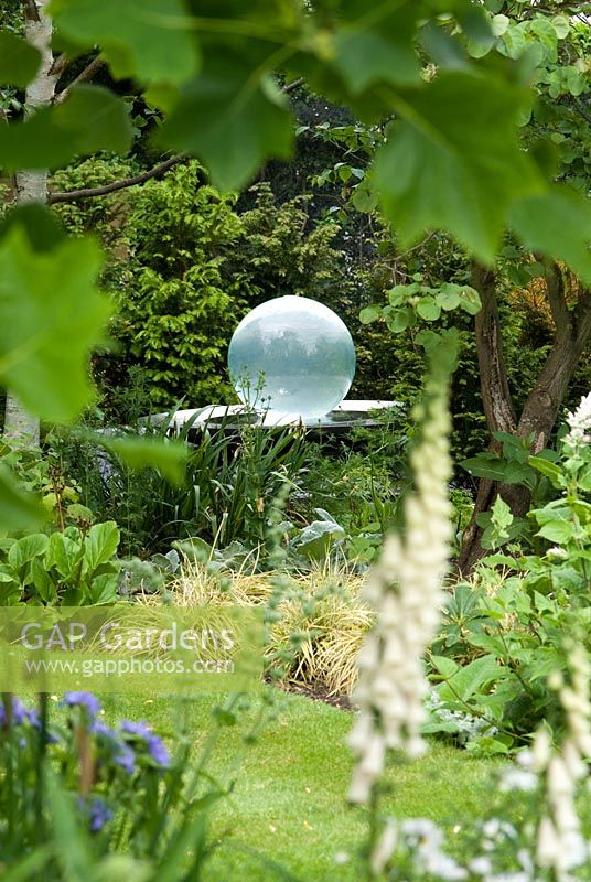 Allison Armour-Wilson's acrylic Aqualens - Acrylic ball water seen through the leaves of a Liriodendron tulipifera in June at Richard Ayres' Garden, Lode, Cambridgeshire