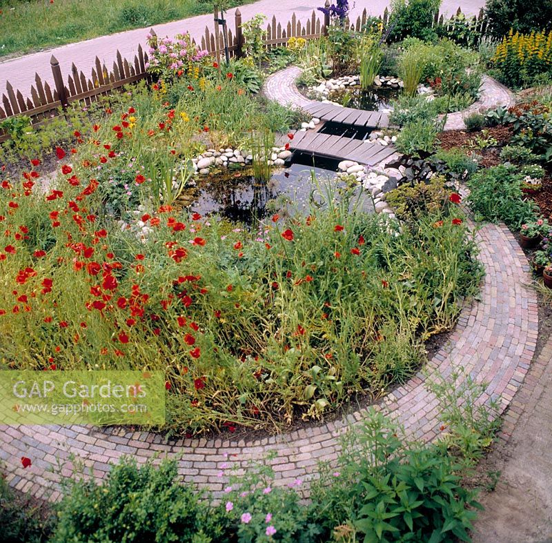 Circular ponds with bridge and poppies 