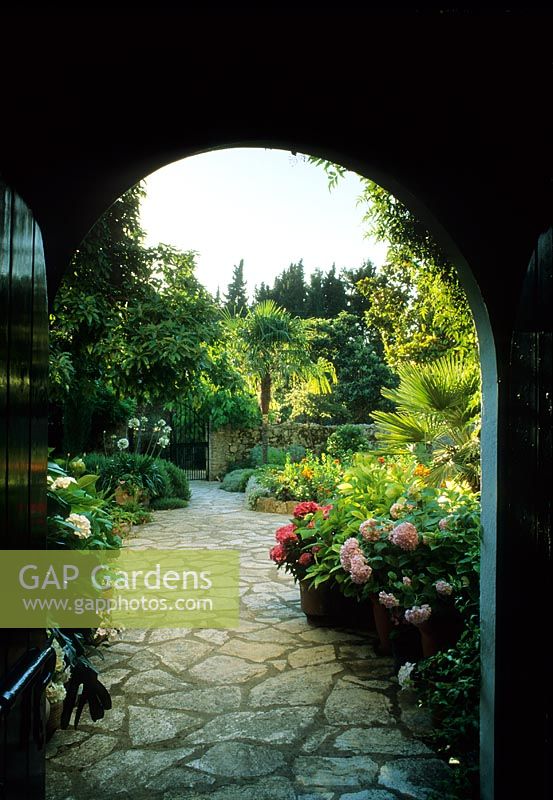 View of mediterranean garden through archway - Cali Doxiadis, Corfu  