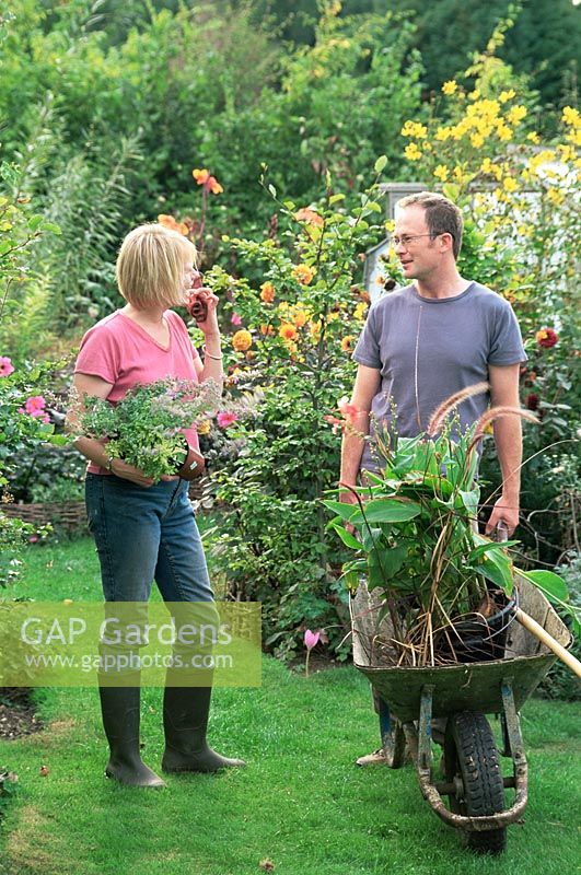 Man and Woman talking in garden whilst gardening