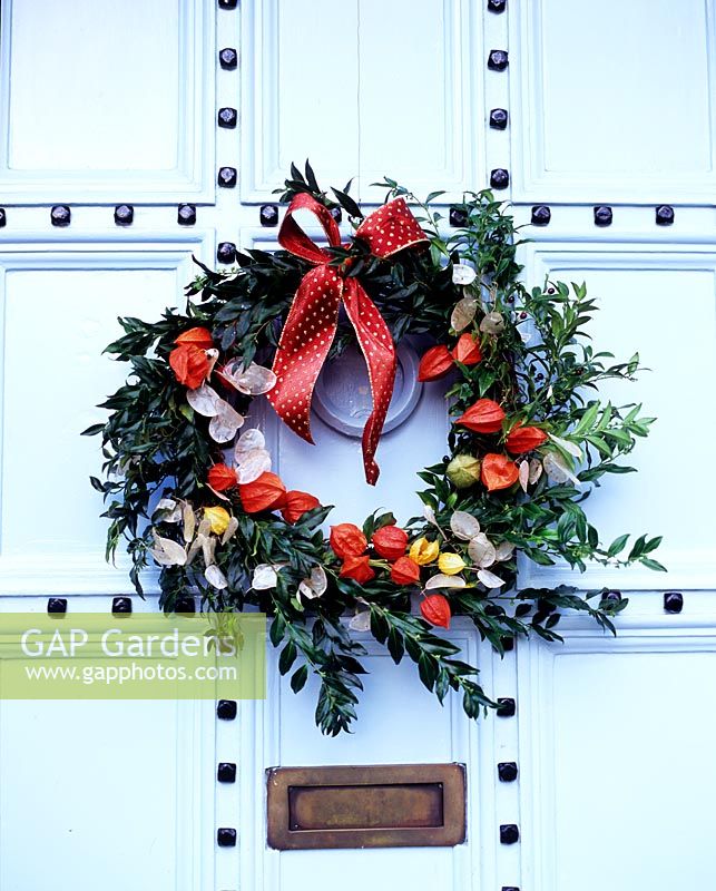 Christmas wreath with Physalis on studded door