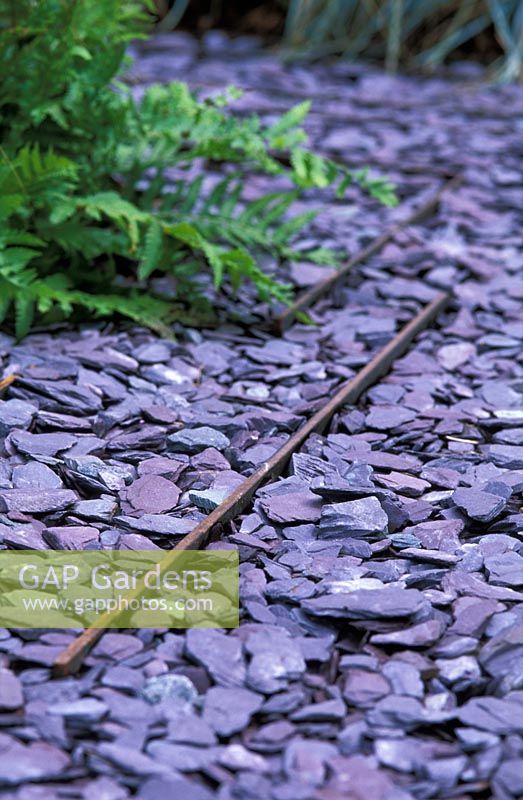 A path of slate chippings with steel retainers