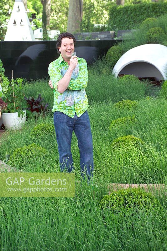 Celebrity garden designer Diarmuid Gavin standing in his RHS Chelsea Flower Show 2005 garden design - Hanover Quay Garden 
