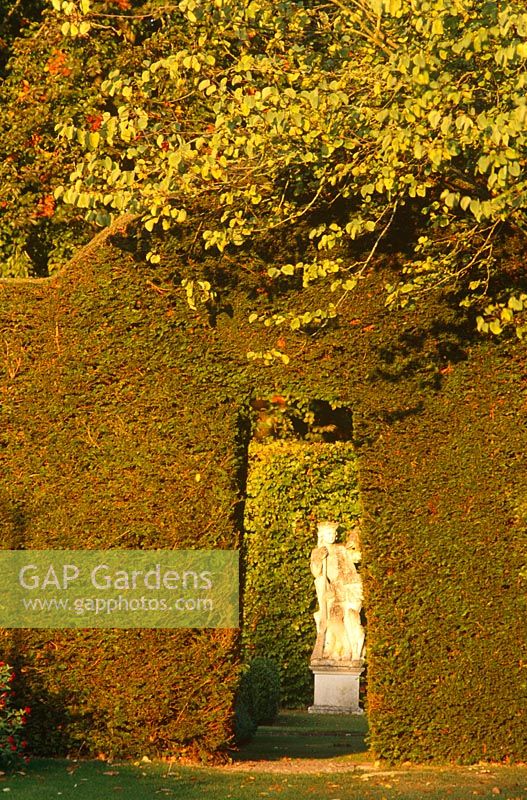 Statue of the Hunter in the Green Garden, seen through a Taxus archway from the Chalk Garden, Cranborne Manor Garden, Cranborne, Dorset